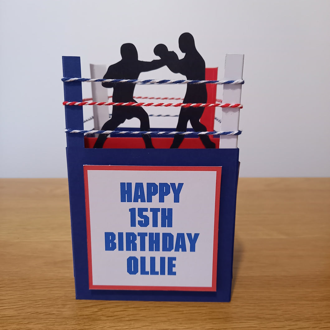 A card made to lok like a boxing ring with ropes and boxers. Can be personalised.