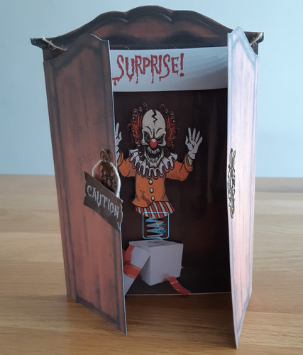 Scary clown jack in the box peeking out of an open wardrobe